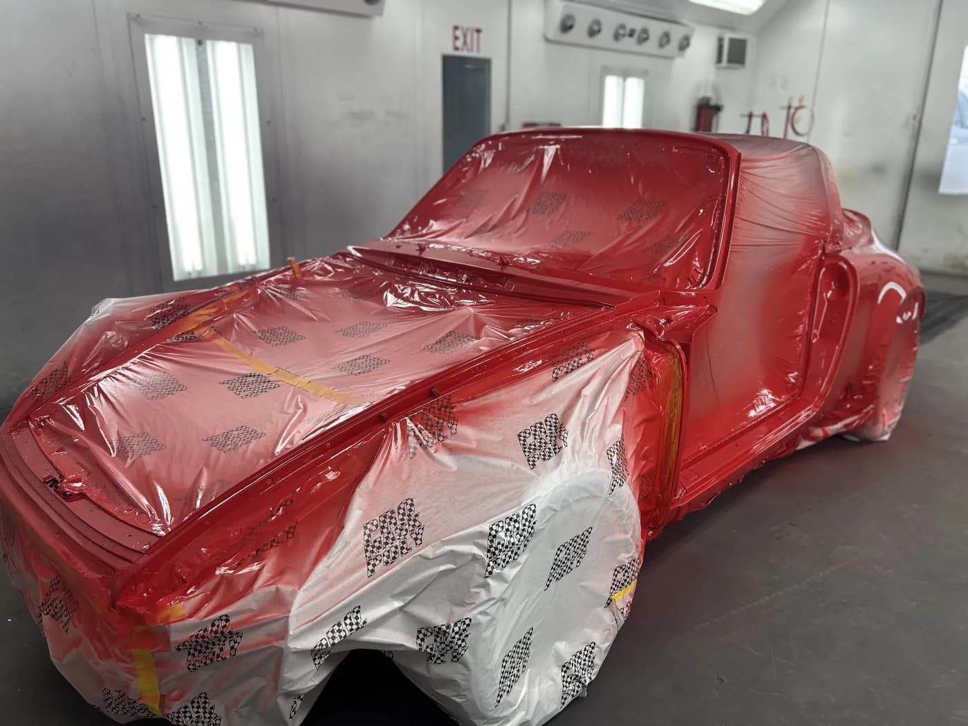 Classic Porsche 911 in deep red, masked.
