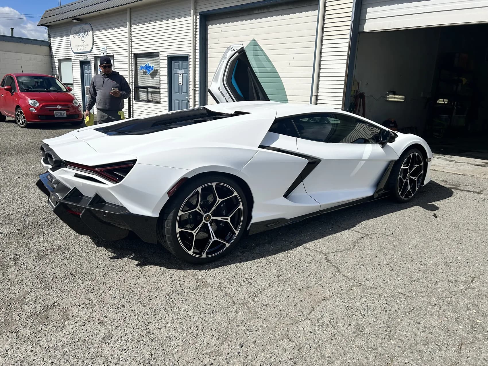 White Lamborghini Revuelto outside the shop.